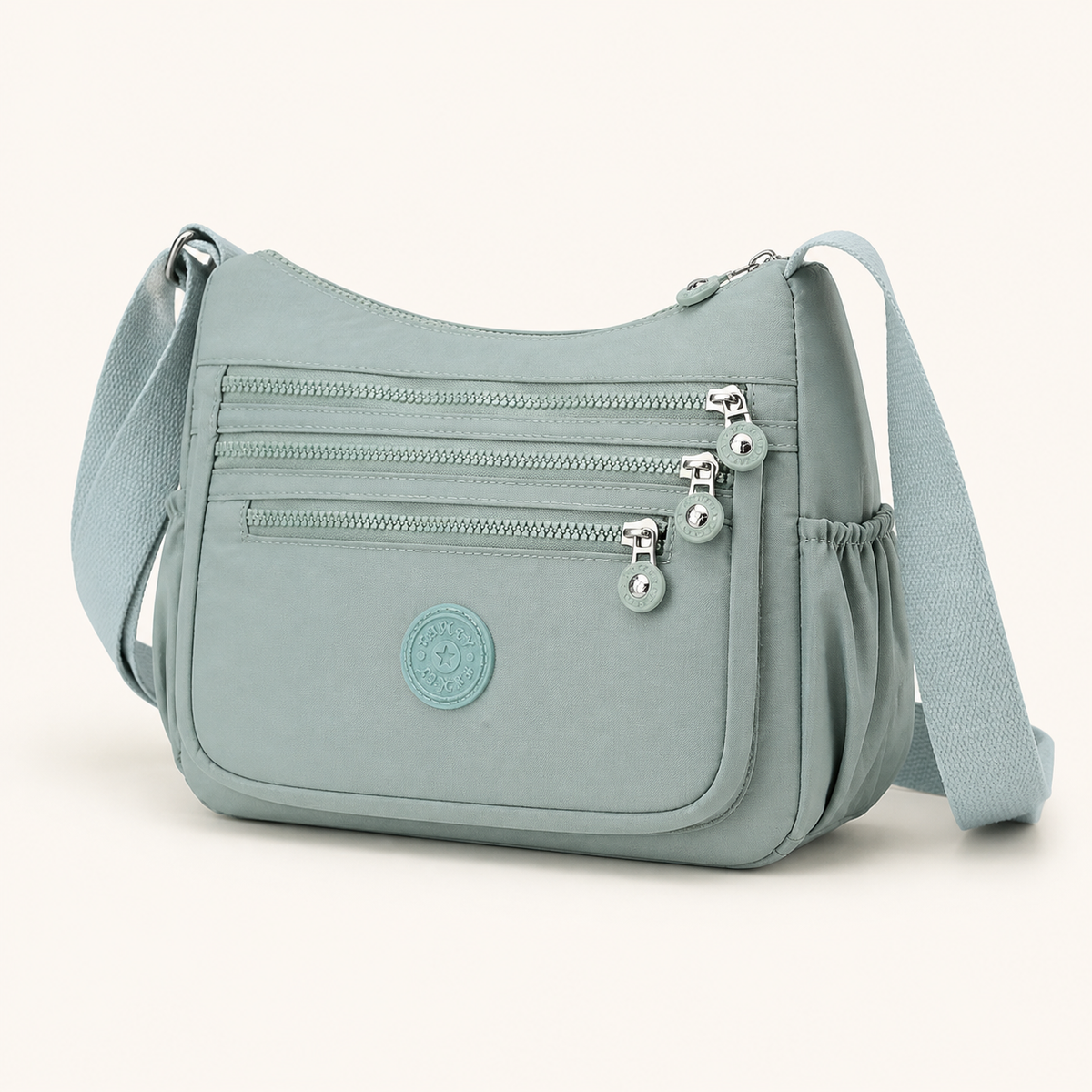 Willa London Everyday Organiser Crossbody Bag in Mint Green, front three-quarter studio view on a warm ivory background
