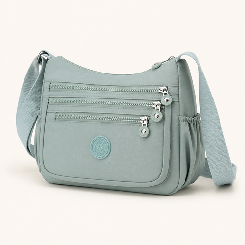 Willa London Everyday Organiser Crossbody Bag in Mint Green, front three-quarter studio view on a warm ivory background