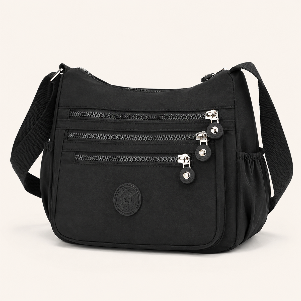 Willa London Everyday Organiser Crossbody Bag in Black, front three-quarter view showing three horizontal zips and silver-tone hardware