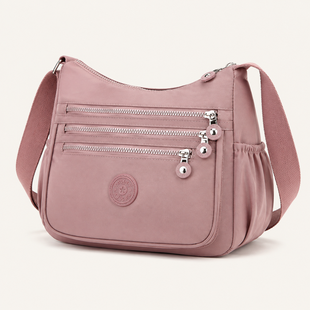Willa London Everyday Organiser Crossbody Bag in Dusty Pink, front three-quarter view on a warm ivory background