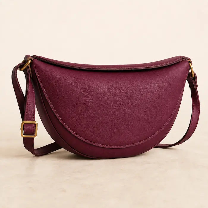 Willa London Crescent Crossbody Bag in Burgundy on a warm ivory background