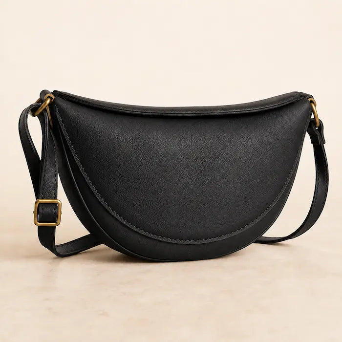 Willa London Crescent Crossbody Bag in Black on a warm ivory background