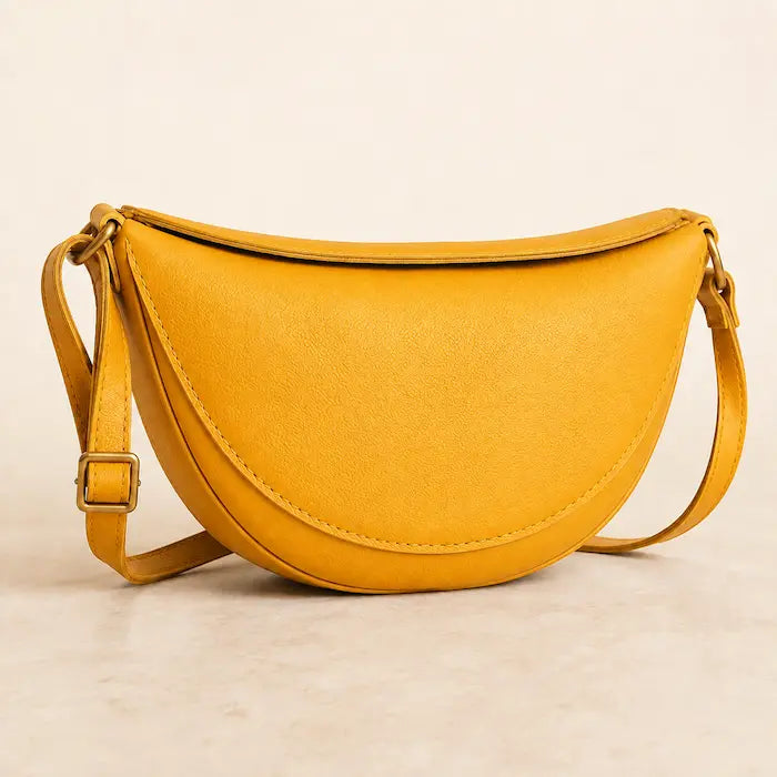 Willa London Crescent Crossbody Bag in Mustard on a warm ivory background