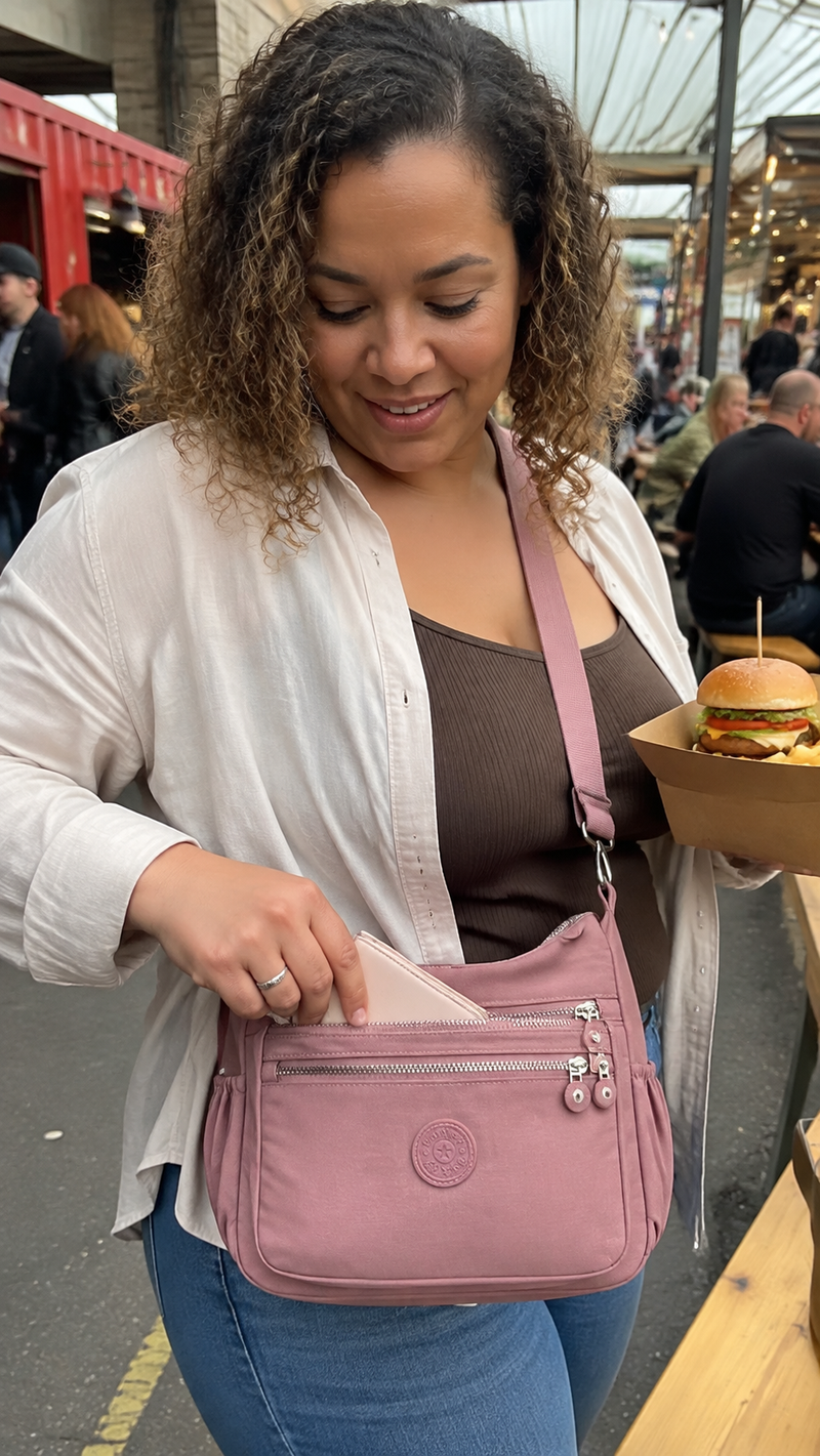 Everyday Organiser Crossbody Bag in Dusty Pink photographed at a Liverpool food market